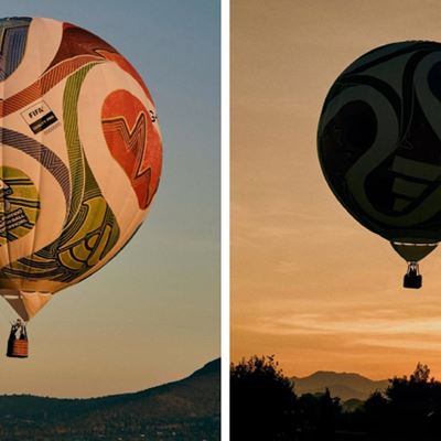 Two images of a hot air balloon designed to look like a colorful soccer ball with various patterns and logos. The left image shows the balloon in daylight against a clear sky with hills in the background, while the right image captures the balloon as a dark silhouette against a warm, orange sunset sky with trees and mountains in the distance.